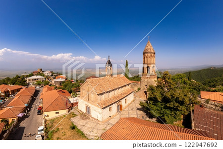 Aerial view on St. George's Church and Alazani valley, Georgia, Kakheti region, Signagi village. Sighnaghi city of love on hill near Gombori Range. Drone Photography in sunny summer day. Aerial view on St. George's Church and Alazani valley, Georgia, Kakheti region, Signagi village. Sighnaghi city of love on hill near Gombori Range. Drone Photography in sunny summer day. 122947692