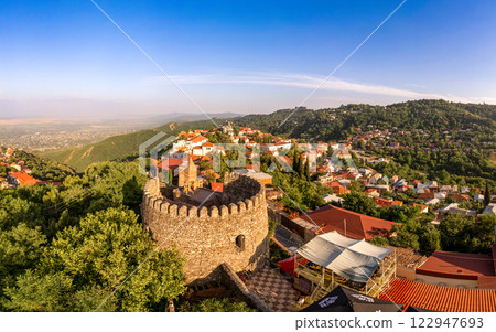 Aerial view on St. George's Church and Alazani valley, Georgia, Kakheti region, Signagi village. Sighnaghi city of love on hill near Gombori Range. Drone Photography in sunny summer day. 122947693