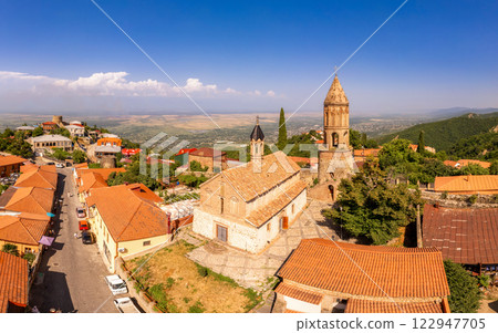 Aerial view on St. George's Church and Alazani valley, Georgia, Kakheti region, Signagi village. Sighnaghi city of love on hill near Gombori Range. Drone Photography in sunny summer day. 122947705