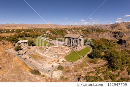 Aerial view of famous Garni pagan temple with Ionic-colonnaded. Historic Greek style building is located on gorge. Built in I century AD by Armenian king Trdat. Ancient Khosrov Reserve, Armenia Europe 122947709