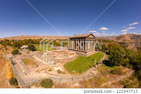 Aerial view of famous Garni pagan temple with Ionic-colonnaded. Historic Greek style building is located on gorge. Built in I century AD by Armenian king Trdat. Ancient Khosrov Reserve, Armenia Europe 122947713