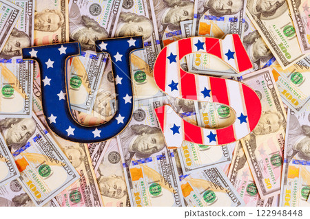 Letters, US, are placed on spread of assorted American dollars banknotes, symbolizing money, commerce in United States. Letters, US, are placed on spread of assorted American dollars banknotes, symbolizing money, commerce in United States. 122948448
