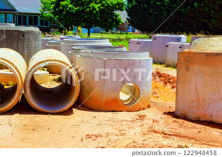 Concrete pipes, infrastructure parts are arranged at construction site ready for installation. Concrete pipes, infrastructure parts are arranged at construction site ready for installation. 122948458