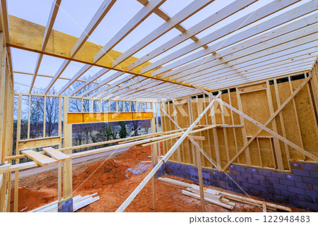 Construction are building wooden beams frame in rural setting, under works day Construction are building wooden beams frame in rural setting, under works day 122948483