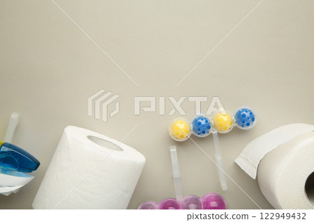 Toilet balls and toilet paper on grey background. Clean the toilet bowl with cleaning and refreshing balls. Toilet balls and toilet paper on grey background. Clean the toilet bowl with cleaning and refreshing balls. 122949432
