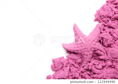 Pink kinetic sand for children, development and play at home with multi-colored sandbox molds isolated on white background. Pink kinetic sand for children, development and play at home with multi-colored sandbox molds isolated on white background. 122949490