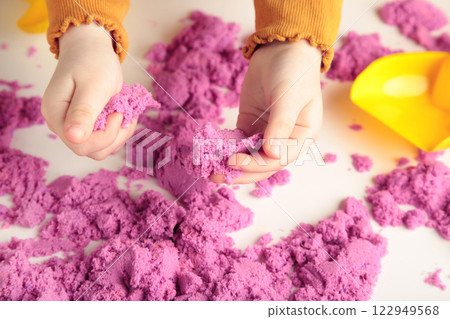 Kids creativity. Kinetic sand games for child development at home. Sand therapy. Children's hands making starfish. 122949568