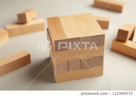 Blocks of wood on grey background, Strategy game as a business plan for team work Blocks of wood on grey background, Strategy game as a business plan for team work 122949573