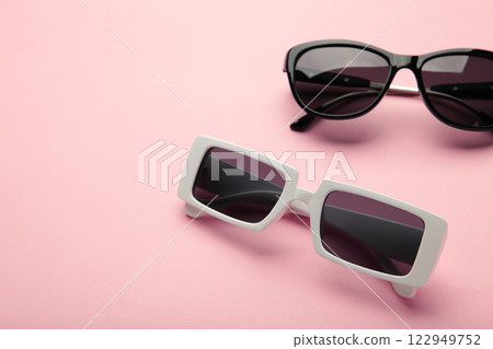 White and black sunglasses on pink background, top view, flat lay, minimalistic concept of summer, vacation White and black sunglasses on pink background, top view, flat lay, minimalistic concept of summer, vacation 122949752