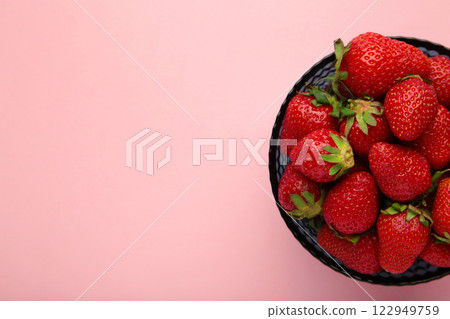 Ripe strawberries in bowl on pink background. Space for text 122949759