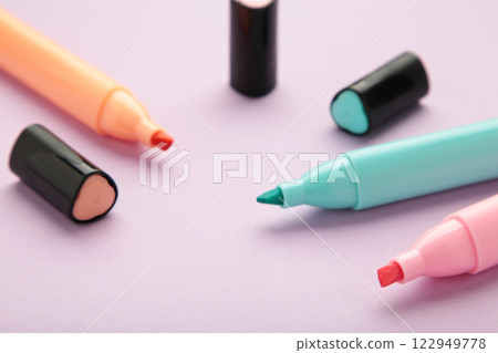 Open markers and space for text on purple background. 122949778