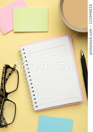 To do list written in a notebook. Notebook with an to do list on beige with cup of coffee and clock To do list written in a notebook. Notebook with an to do list on beige with cup of coffee and clock 122949818