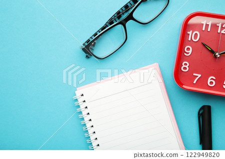 To do list written in a notebook. Notebook with an to do list on blue with cup of coffee and clock 122949820