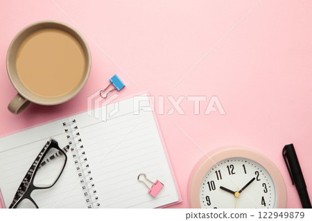 To do list written in a notebook. Notebook with an to do list on pink with cup of coffee and clock To do list written in a notebook. Notebook with an to do list on pink with cup of coffee and clock 122949879