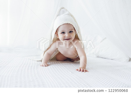 Little cute child wearing hooded towel after bath or shower. Little cute child wearing hooded towel after bath or shower. 122950068