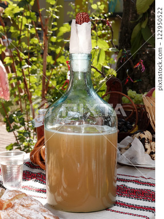 An antique bottle of drink on a festive table in Ukraine 122950522