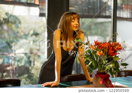 Smiling Woman in a Bright Modern Kitchen 122950589