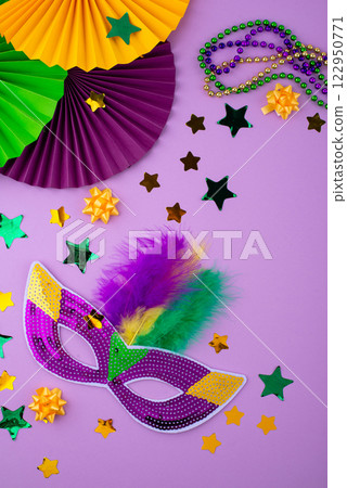 Vibrant Mardi Gras background with mask, beads, and festive decorations 122950771