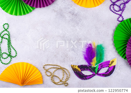 Vibrant Mardi Gras background with mask, beads, and festive decorations 122950774
