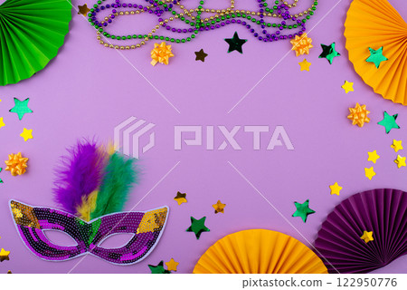 Vibrant Mardi Gras background with mask, beads, and festive decorations Vibrant Mardi Gras background with mask, beads, and festive decorations 122950776
