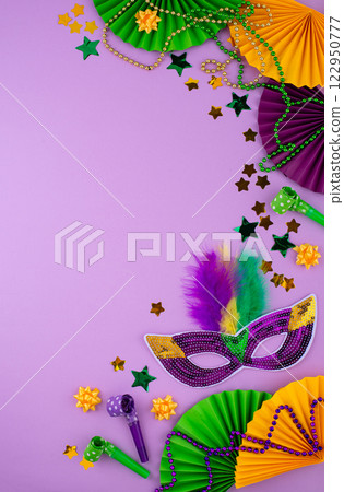 Vibrant Mardi Gras background with mask, beads, and festive decorations Vibrant Mardi Gras background with mask, beads, and festive decorations 122950777