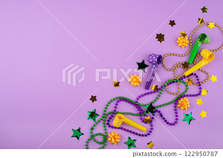 Vibrant Mardi Gras background with mask, beads, and festive decorations Vibrant Mardi Gras background with mask, beads, and festive decorations 122950787