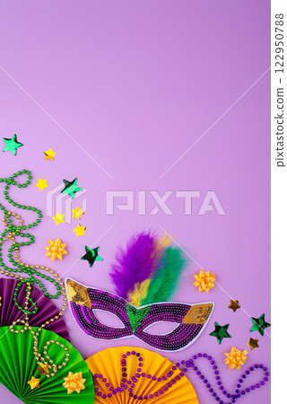 Vibrant Mardi Gras background with mask, beads, and festive decorations Vibrant Mardi Gras background with mask, beads, and festive decorations 122950788
