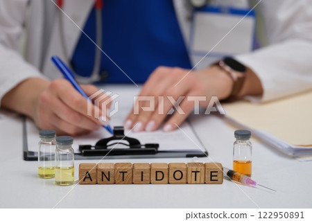 A qualified medical professional is writing a prescription for essential antidote vials 122950891
