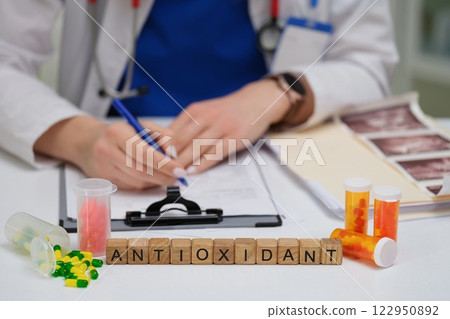 A Medical Professional Writing Detailed Notes on Antioxidants, Medications, and More 122950892