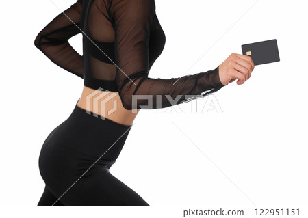athletic fitness woman in sport wear holding black premium credit bank card on white background. payment online athletic fitness woman in sport wear holding black premium credit bank card on white background. payment online 122951151