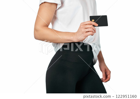 female hand holding black premium credit bank card on white background. credit card for online payment 122951160