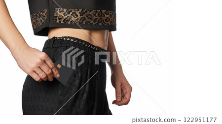 female hand putting black premium credit bank card in pants pocket. Money finance, copy space 122951177