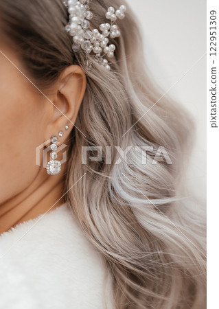 Bridal jewelry earrings and hair jewelry on the bride close up. High quality photo Bridal jewelry earrings and hair jewelry on the bride close up. High quality photo 122951309