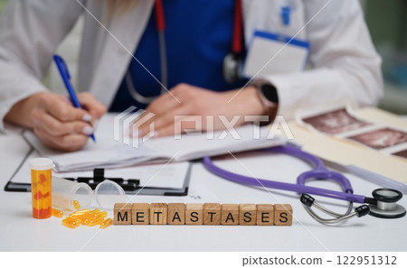 A Medical Professional Conducting a Thorough Analysis of Metastases in a Clinical Setting A Medical Professional Conducting a Thorough Analysis of Metastases in a Clinical Setting 122951312