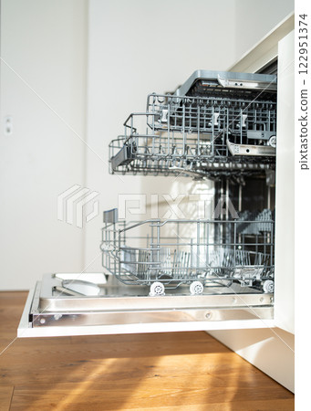 open built-in empty dishwasher with shelves extended . High quality photo open built-in empty dishwasher with shelves extended . High quality photo 122951374