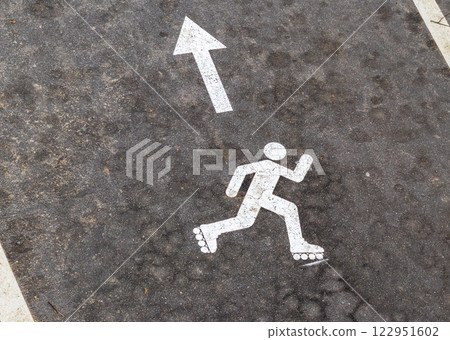 Shot of the paint marking on the asphalt indicating roller skating path Shot of the paint marking on the asphalt indicating roller skating path 122951602