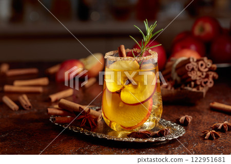 Apple cider with apple slices and a rosemary branch. 122951681