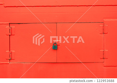 Close up red metal windows on red wall with old lock. 122951688