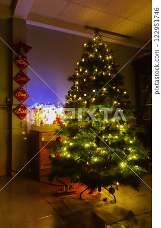 Christmas Tree with Book and Nativity Scene Festive Holiday Decorations and Cozy Seasonal Atmosphere. High quality photo 122951746