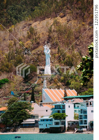 Vung Tau Beach with Blue Sky Flowers and Mother Mary Statue Scenic Coastal View with Coffee Shop Nearby High quality photo Vung Tau Beach with Blue Sky Flowers and Mother Mary Statue Scenic Coastal View with Coffee Shop Nearby High quality photo 122951796