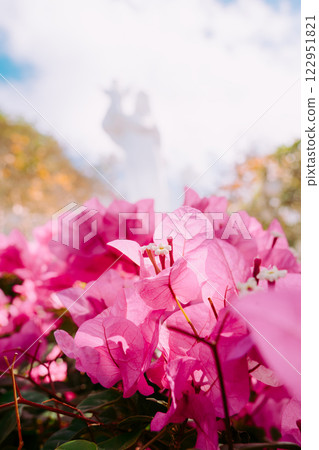 Vung Tau Beach with Blue Sky Flowers and Mother Mary Statue Scenic Coastal View with Coffee Shop Nearby High quality photo Vung Tau Beach with Blue Sky Flowers and Mother Mary Statue Scenic Coastal View with Coffee Shop Nearby High quality photo 122951821
