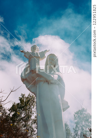Vung Tau Beach with Blue Sky Flowers and Mother Mary Statue Scenic Coastal View with Coffee Shop Nearby High quality photo 122951825