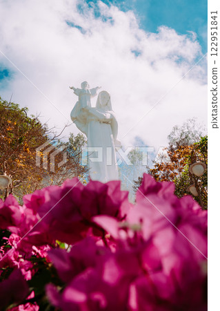 Vung Tau Beach with Blue Sky Flowers and Mother Mary Statue Scenic Coastal View with Coffee Shop Nearby High quality photo 122951841