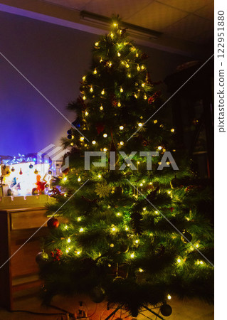 Christmas Tree with Book and Nativity Scene Festive Holiday Decorations and Cozy Seasonal Atmosphere. High quality photo 122951880