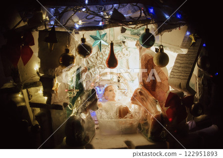 Christmas Tree with Book and Nativity Scene Festive Holiday Decorations and Cozy Seasonal Atmosphere. High quality photo 122951893