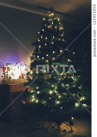 Christmas Tree with Book and Nativity Scene Festive Holiday Decorations and Cozy Seasonal Atmosphere. High quality photo 122951959