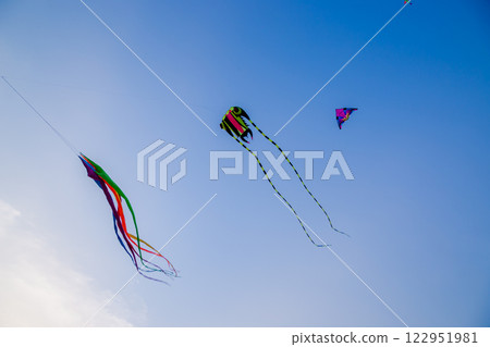 Kids Flying Kites Under a Clear Sky Peaceful and Joyful Outdoor Scene. High quality photo 122951981