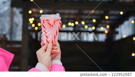Pink takeout cup with candy cane heart raises waste awareness, since waste from single-use containers harms scenic winter vibe, urging mindful choices that reduce waste for future seasons. Pink takeout cup with candy cane heart raises waste awareness, since waste from single-use containers harms scenic winter vibe, urging mindful choices that reduce waste for future seasons. 122952087