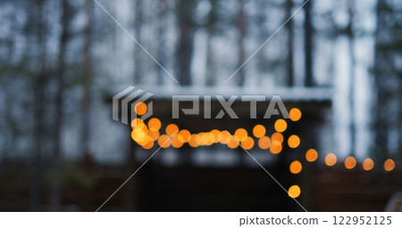 Bokeh glimmers in softly lit winter scene, capturing holiday warmth as bokeh flows through shimmering background, revealing bokeh illusions that evoke magical holiday cheer for viewers. 122952125