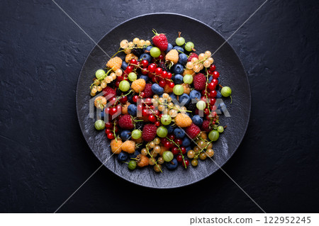 Black plate with multicolored assorted mix berries 122952245
